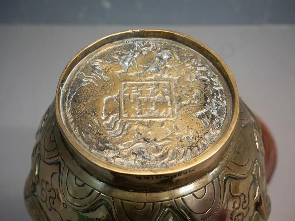 heavy brass vase with deep figural Chinese style relief dragon motifs, marked Made in India, with timber stand. Damage Image 1++