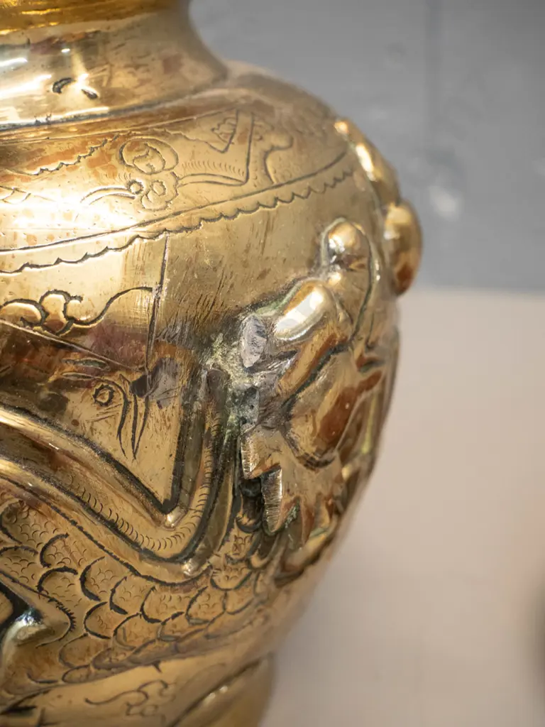 heavy brass vase with deep figural Chinese style relief dragon motifs, marked Made in India, with timber stand. Damage Image 1++