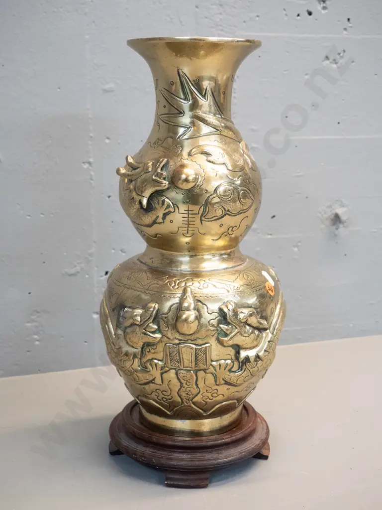 heavy brass vase with deep figural Chinese style relief dragon motifs, marked Made in India, with timber stand. Damage Image 1++