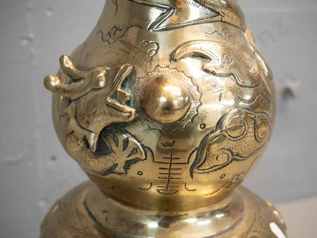 heavy brass vase with deep figural Chinese style relief dragon motifs, marked Made in India, with timber stand. Damage Image 1++