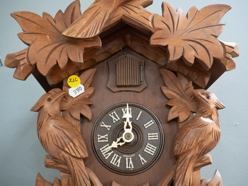 wood-cased cuckoo clock with cast metal weights and plastic face marked Germany - some minor chips to finish (not going) Image 1++