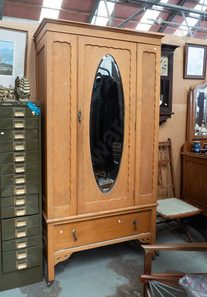 vintage oak wardrobe with oval bevelled edge mirror, oval panels to sides, bottom drawer with drop handles, on square Image 1++