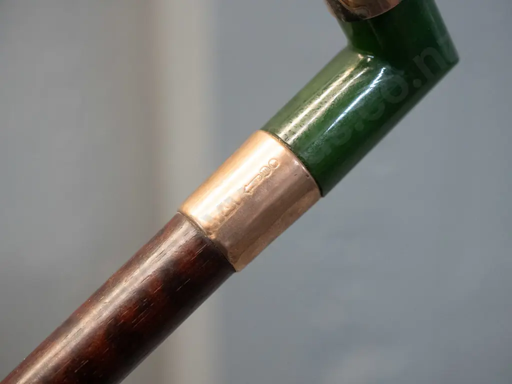 2 walking canes with right-angle heads - one with greenstone handle and hallmarked gold bands L920, other with plated Image 1++