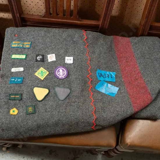 grey woollen Scout blanket with various badges