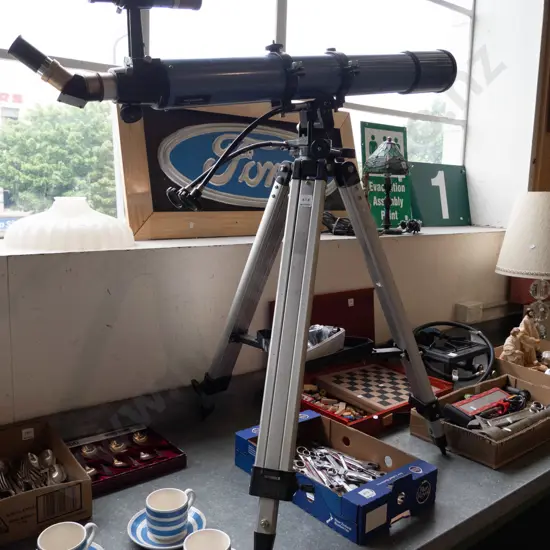 astronomical telescope on tripod with additional box of lenses
