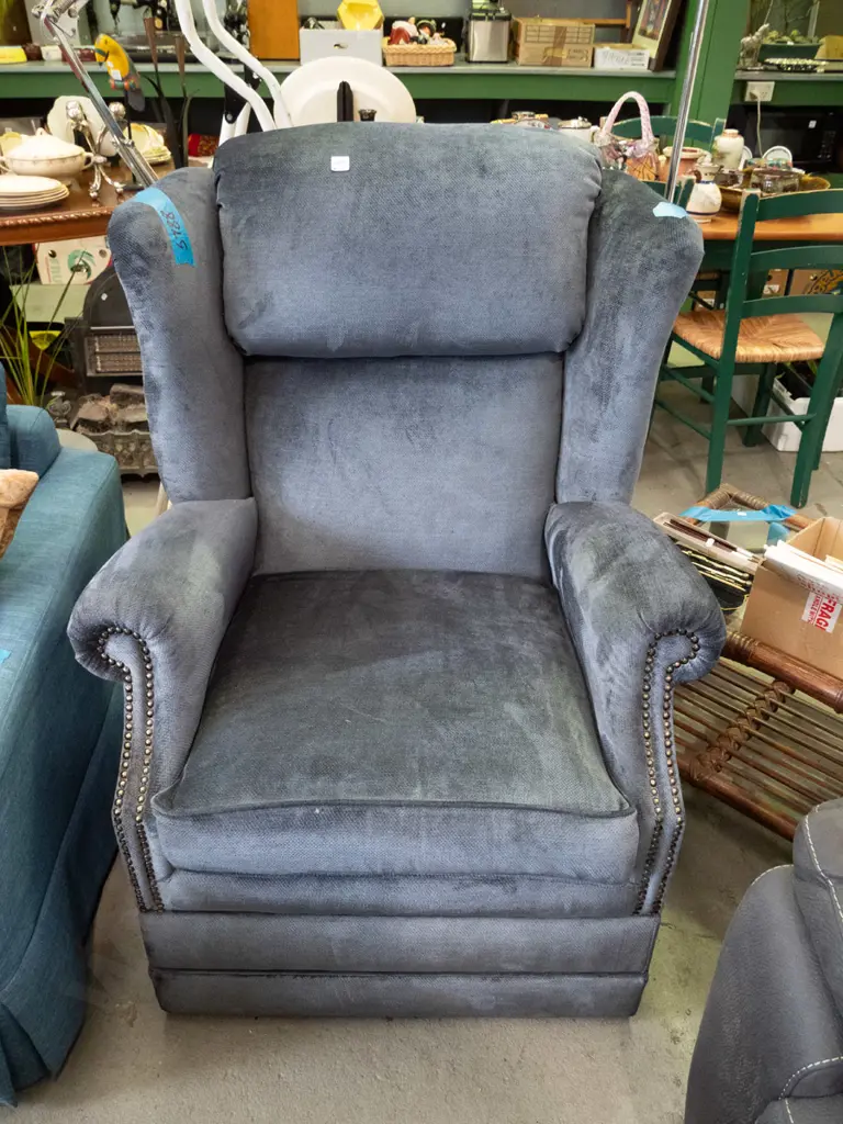 blue upholstered and dome studded wingback armchair Image 1++