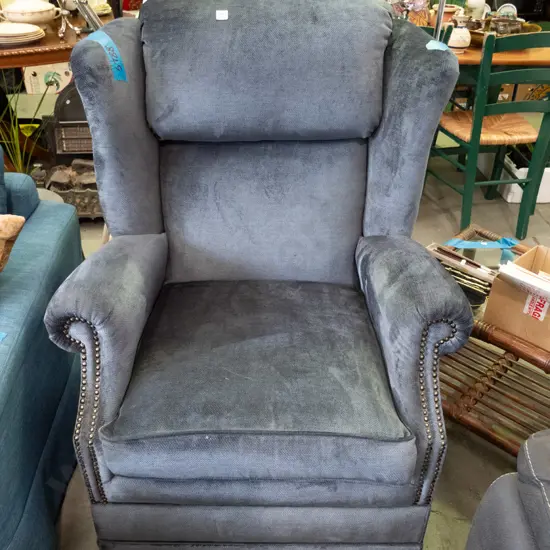 blue upholstered and dome studded wingback armchair