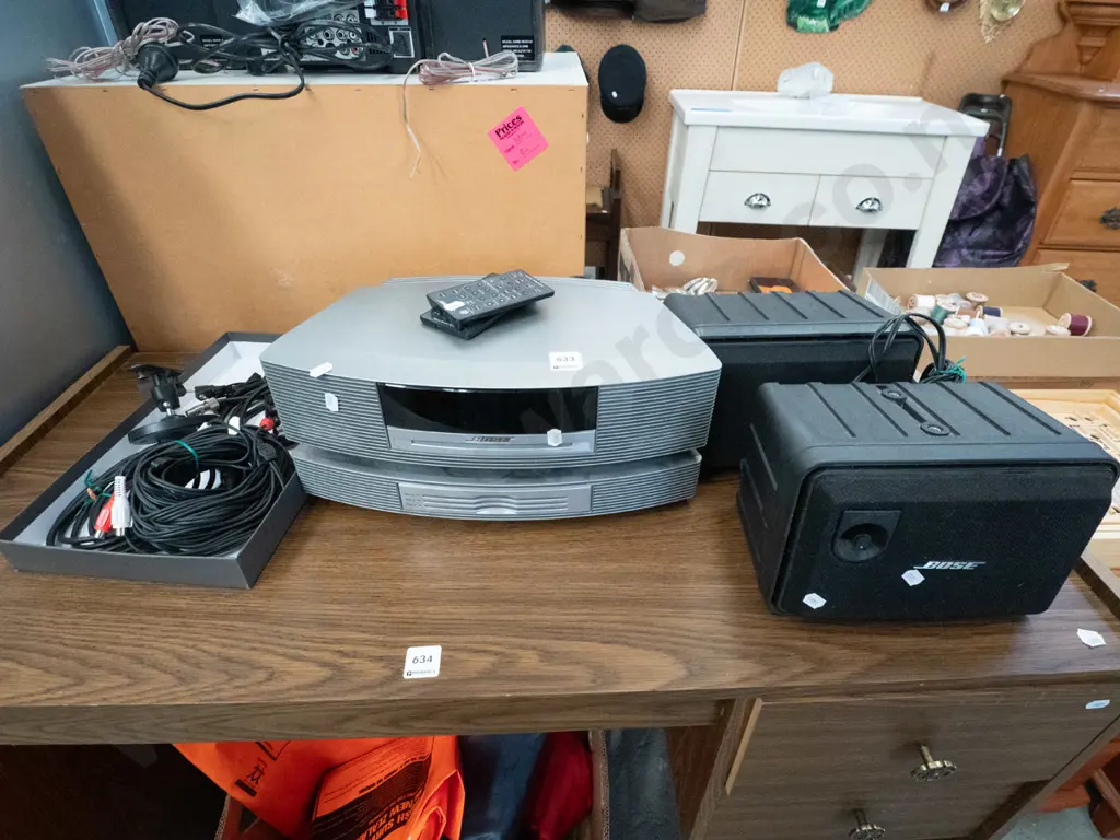 Bose stereo system with 2 wall mounted speakers and remotes- remotes in office Image 1++