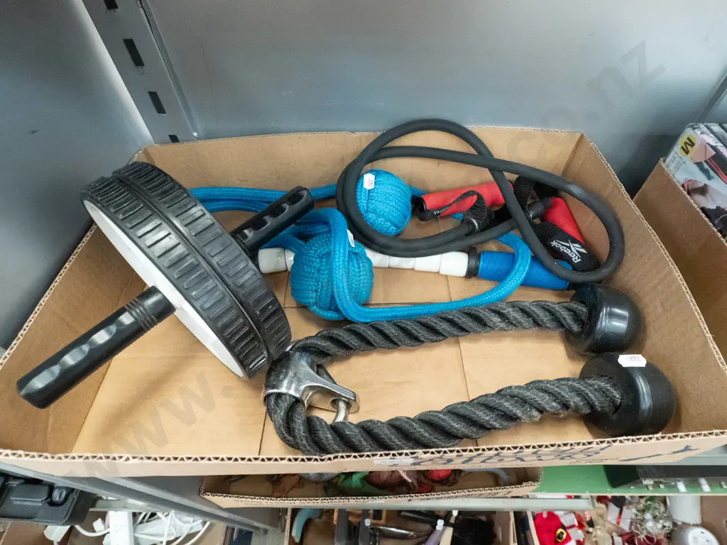 box of exercise equipment, skipping ropes, wheel etc Image 1++