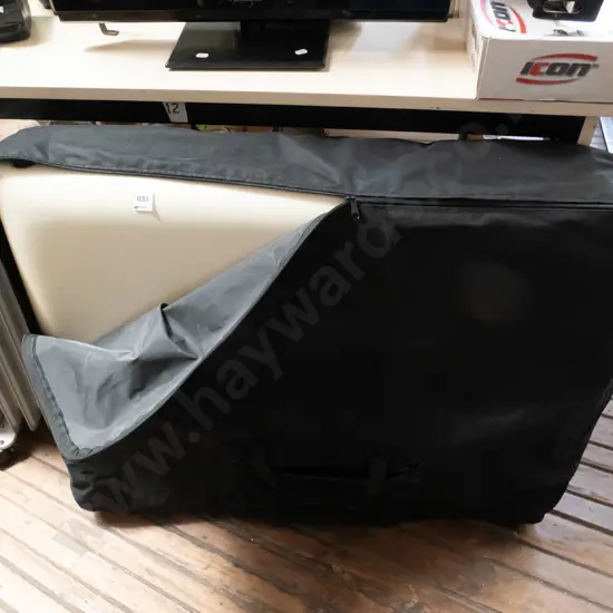 white vinyl massage table in case