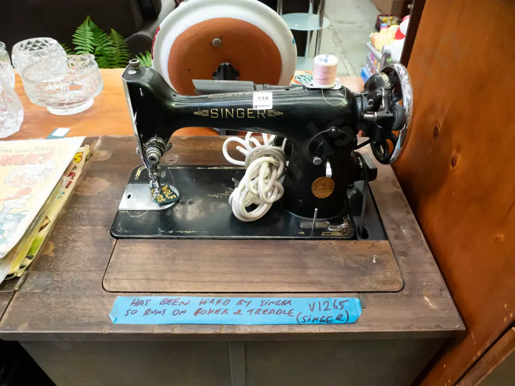 Singer treadle/electric sewing machine in cabinet - cabinet needs attention Image 1++
