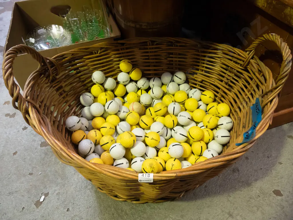 cane wood basket filled with driving range golf balls Image 1++