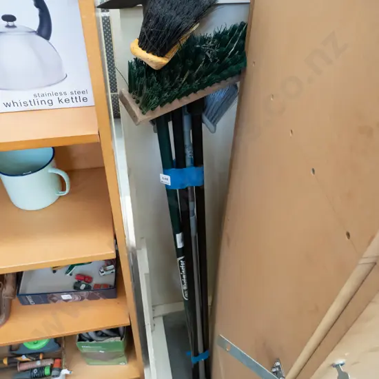 bundle of brooms, garden hoe