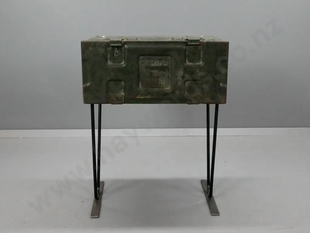 side table made from metal ammunition case on black painted metal base. General age wear and pitting to paint, wobbly Image 1++