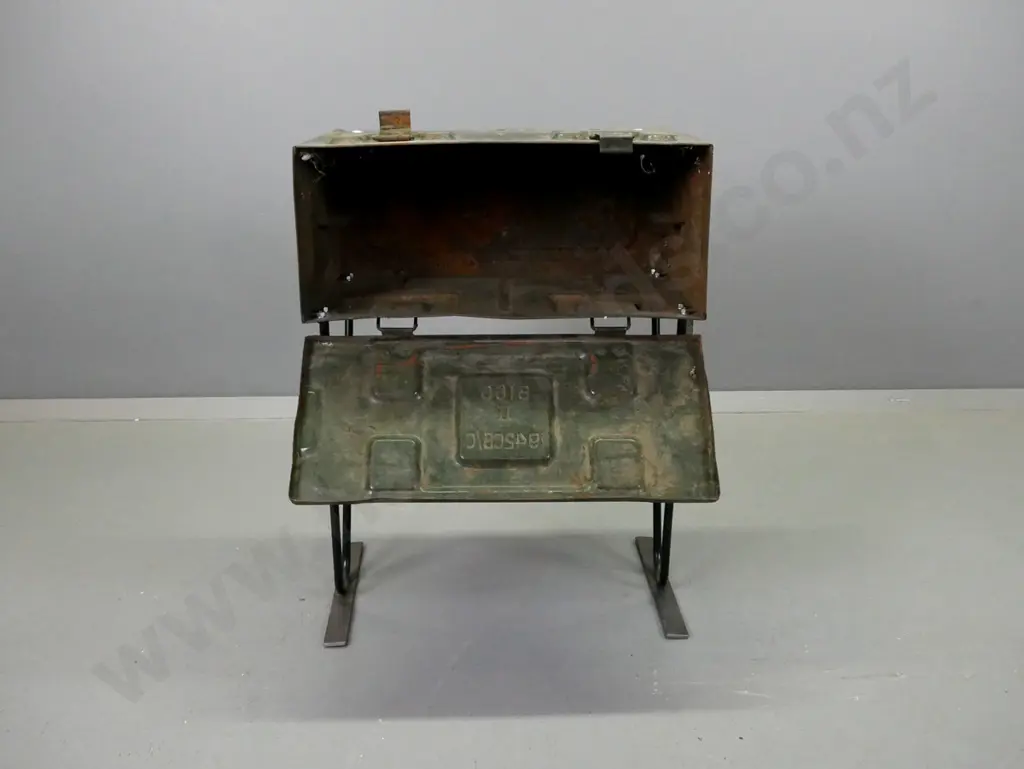 side table made from metal ammunition case on black painted metal base. General age wear and pitting to paint, wobbly Image 1++