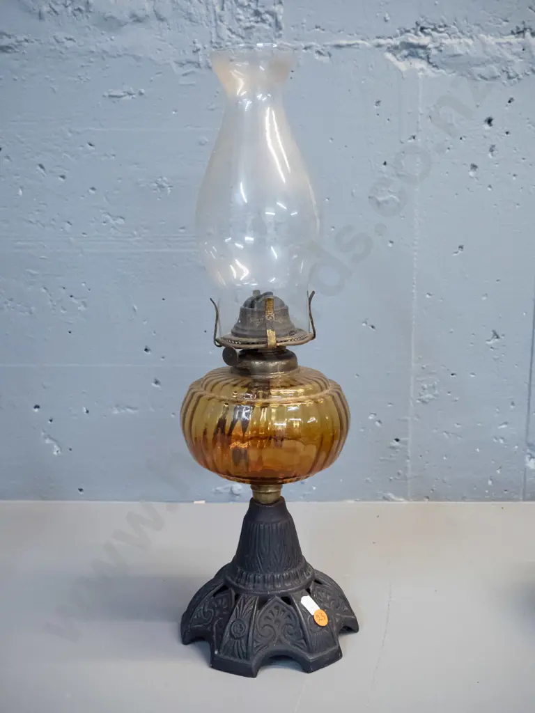vintage kerosene lamp with cast metal base, amber glass reservoir and clear glass chimney H-500 Image 1++
