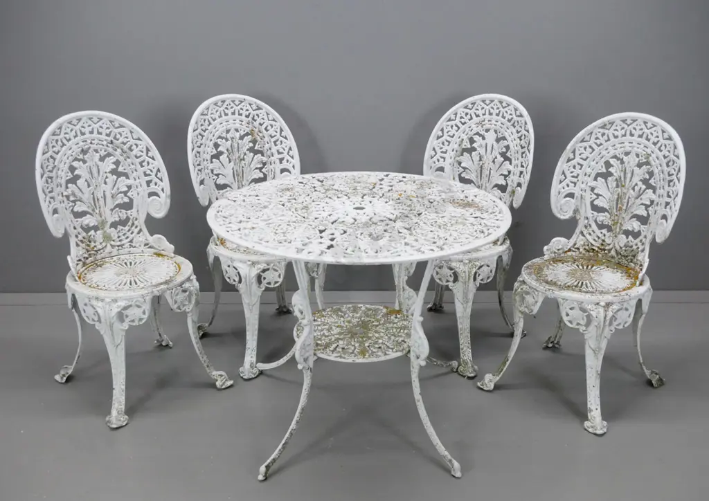 cast alloy white painted patio table and 4 matching chairs, round shelf and umbrella hole in table - overall wear to Image 1++