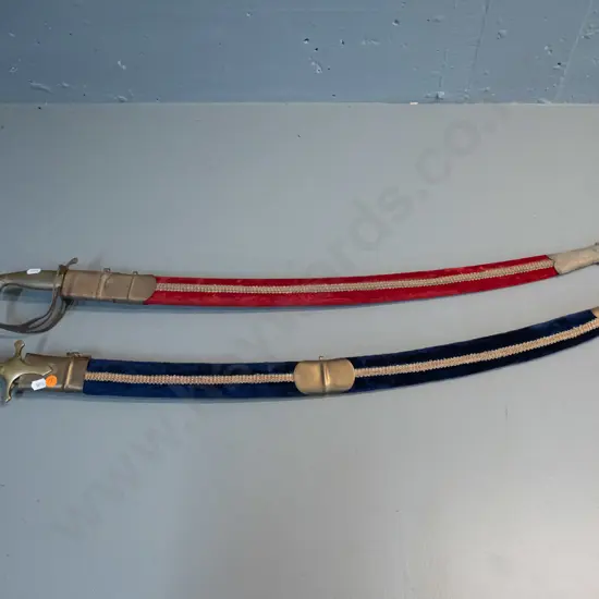 two reproduction Indian souvenir sabres with brass hardware and etched blades, velvet covered scabbards, longer one L970