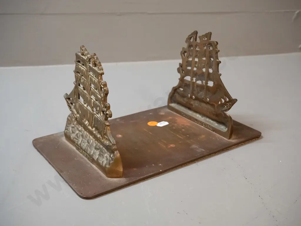 cast brass book stand with fixed ends, sailing ship motif with "Windjammer" on each end. H-130 L-250 D-150 Image 1++