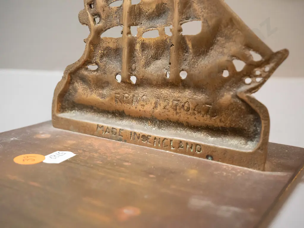 cast brass book stand with fixed ends, sailing ship motif with "Windjammer" on each end. H-130 L-250 D-150 Image 1++
