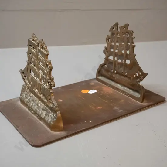 cast brass book stand with fixed ends, sailing ship motif with "Windjammer" on each end. H-130 L-250 D-150