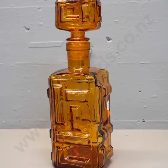 retro Empoli Italy moulded amber glass geometric block pattern stoppered decanter. Minor damage to plastic