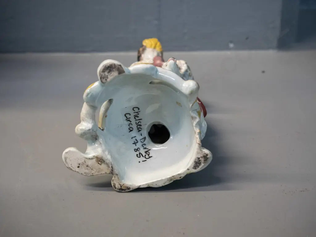 small figurine of man playing bagpipes - has been marked on base "Chelsea Derby circa 1785" - some damage to pipes H-160 Image 1++