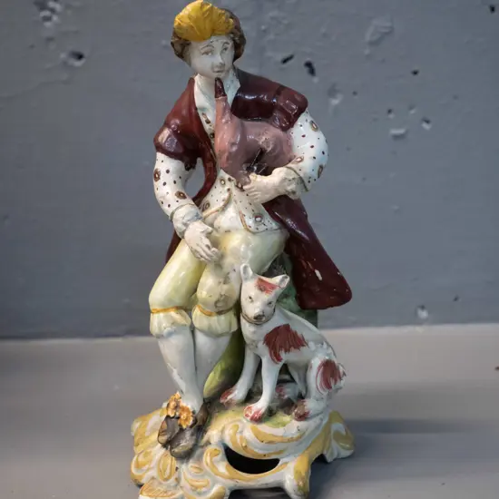 small figurine of man playing bagpipes - has been marked on base "Chelsea Derby circa 1785" - some damage to pipes H-160