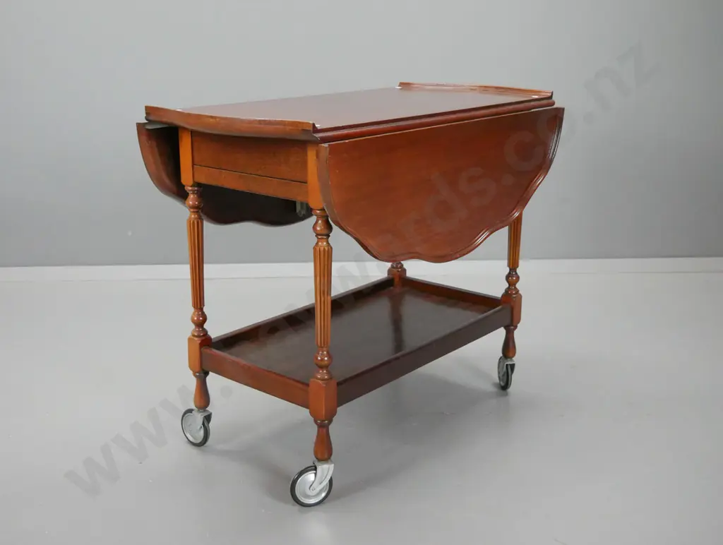 vintage mahogany drop-side tea trolley with shaped moulded top, drawer on one end, pull out baize covered slide on other Image 1++
