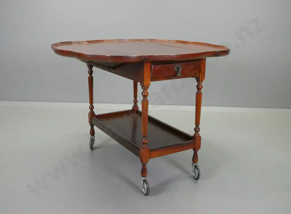 vintage mahogany drop-side tea trolley with shaped moulded top, drawer on one end, pull out baize covered slide on other Image 1++