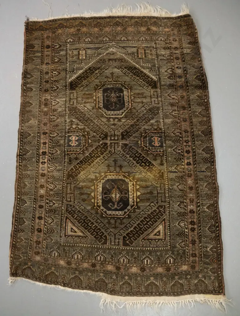small Persian style hand knotted wool prayer rug - earth tones. Colours faded, fringe worn on both ends, some staining Image 1++