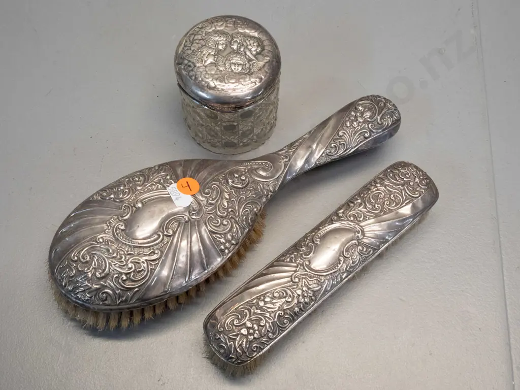 3 pieces of sterling silver dressing table ware - matching hair & clothes brushes and an angel motif sterling lid on a Image 1++
