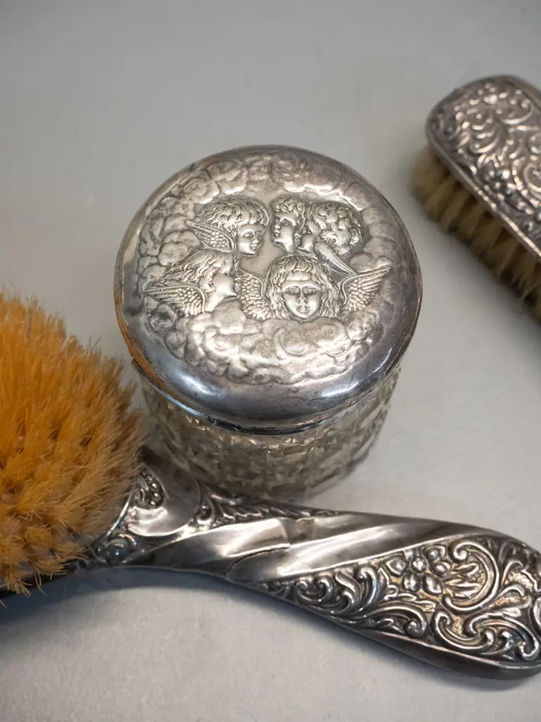 3 pieces of sterling silver dressing table ware - matching hair & clothes brushes and an angel motif sterling lid on a Image 1++