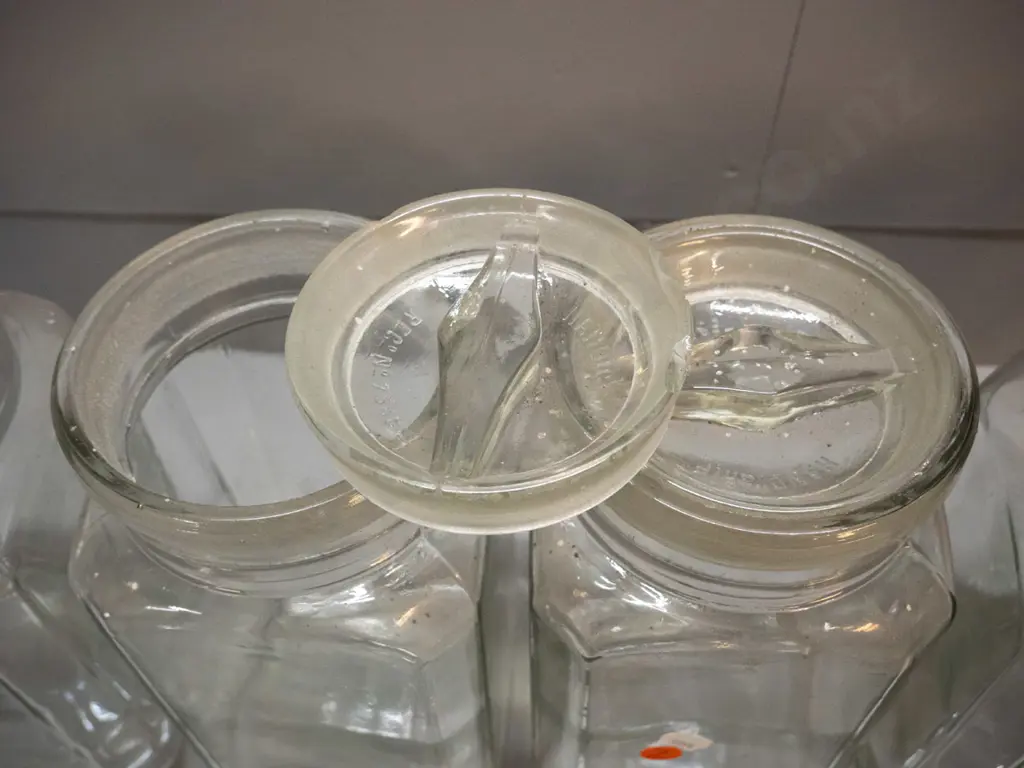 5 vintage glass confectionary / kitchen storage jars - 2 with bakelite lids, 3 w/ glass, 2 are stuck in place. Glass Image 1++
