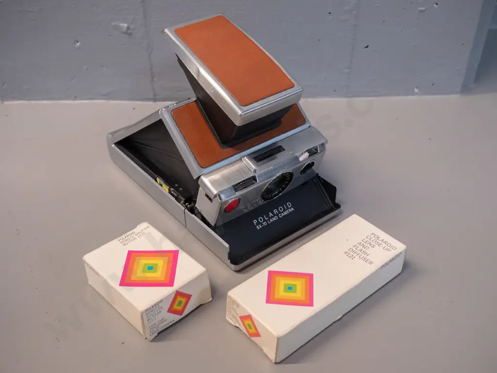 Polaroid SX-70 folding instant camera with boxed cable release and flash attachments - camera opening mechanism a little Image 1++