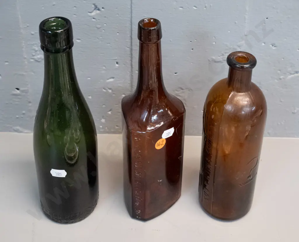 3 vintage glass bottles - heavy green Thomson & Co Dunedin H-260 and 2 brown - Frederick Stearns Michigan and one marked Image 1++