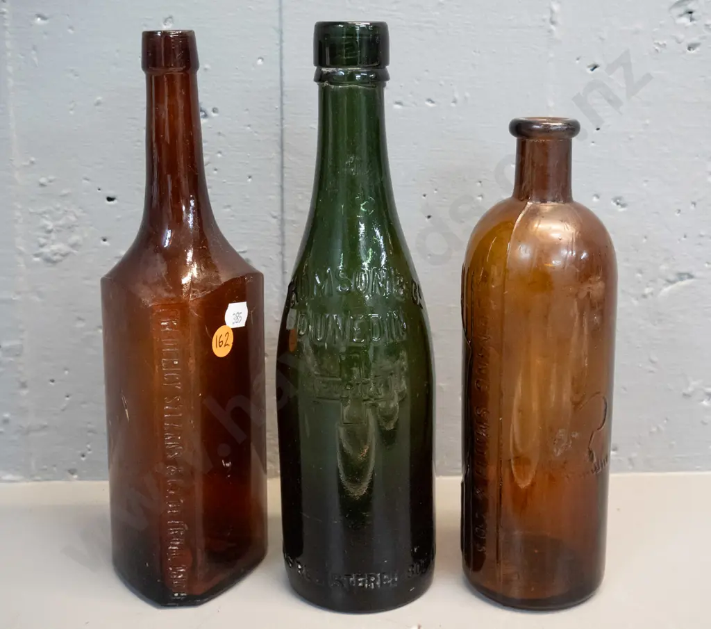 3 vintage glass bottles - heavy green Thomson & Co Dunedin H-260 and 2 brown - Frederick Stearns Michigan and one marked Image 1++