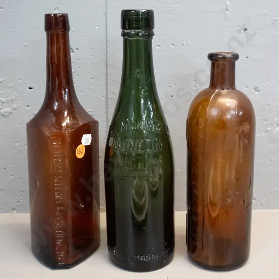 3 vintage glass bottles - heavy green Thomson & Co Dunedin H-260 and 2 brown - Frederick Stearns Michigan and one marked