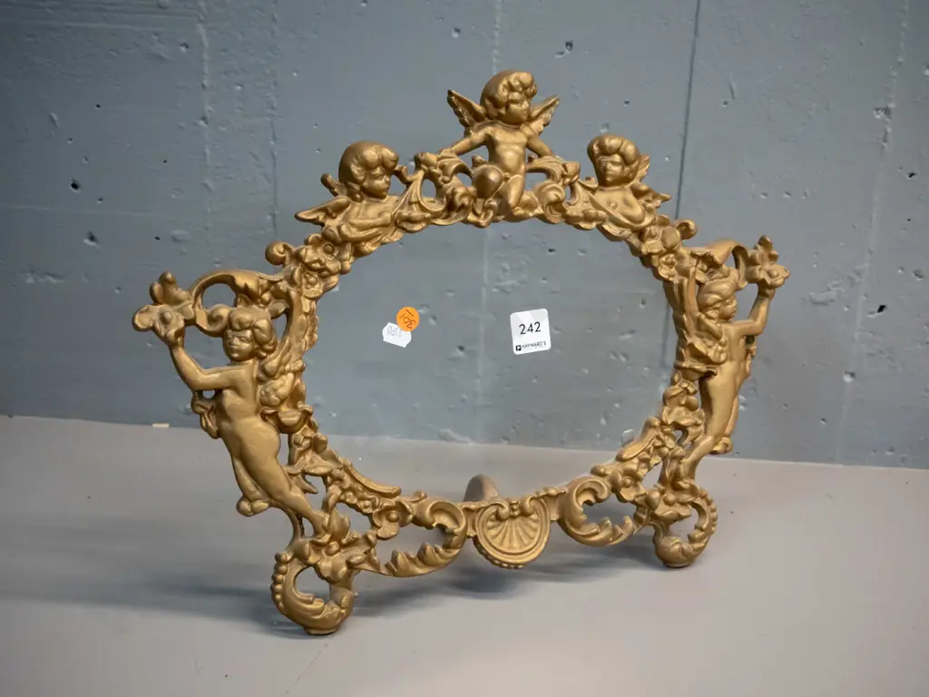 cast metal gilt finish picture frame with ornate putti decoration, glass but no backing H-320 W-425 Image 1++