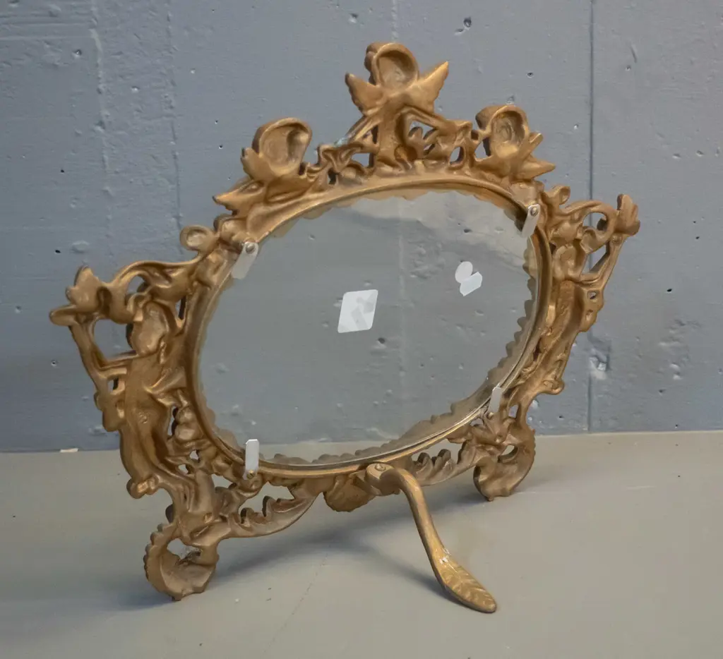 cast metal gilt finish picture frame with ornate putti decoration, glass but no backing H-320 W-425 Image 1++