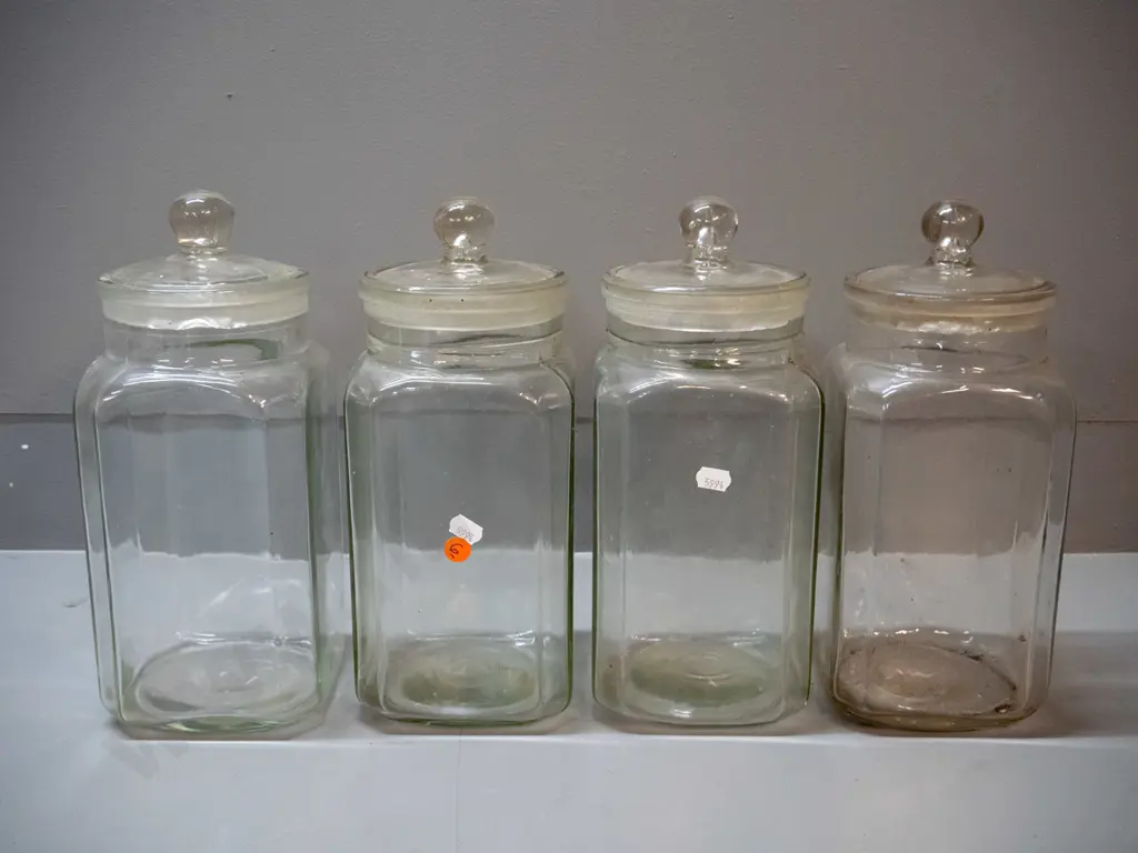 4 vintage glass stoppered confectionary / kitchen storage jars - 3 have lids stuck in place, other lid has chips around Image 1++