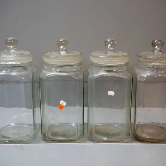 4 vintage glass stoppered confectionary / kitchen storage jars - 3 have lids stuck in place, other lid has chips around