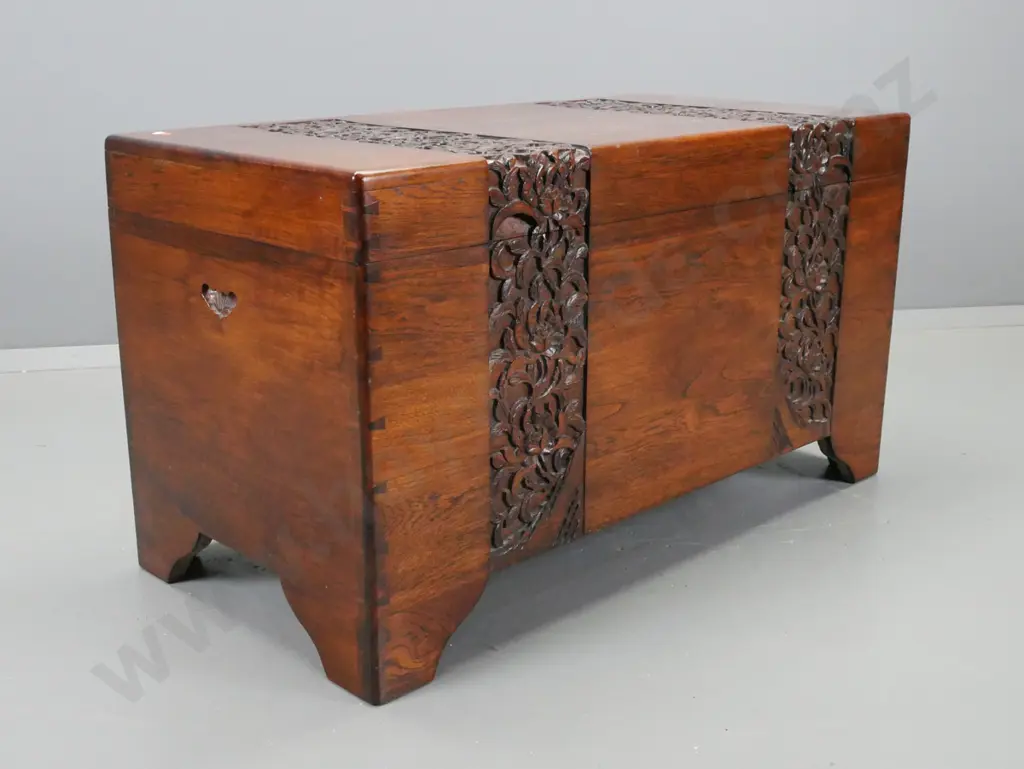 vintage hardwood timber with foliate carved top and front, on shaped feet, cut out carry handles, camphorwood lined with Image 1++
