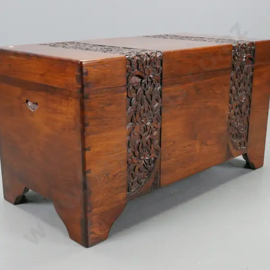 vintage hardwood timber with foliate carved top and front, on shaped feet, cut out carry handles, camphorwood lined with