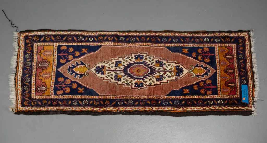hand woven wool floor rug - dark blue, redd and oranges, fading to one end and wear to fringes L1460 W580 Image 1++