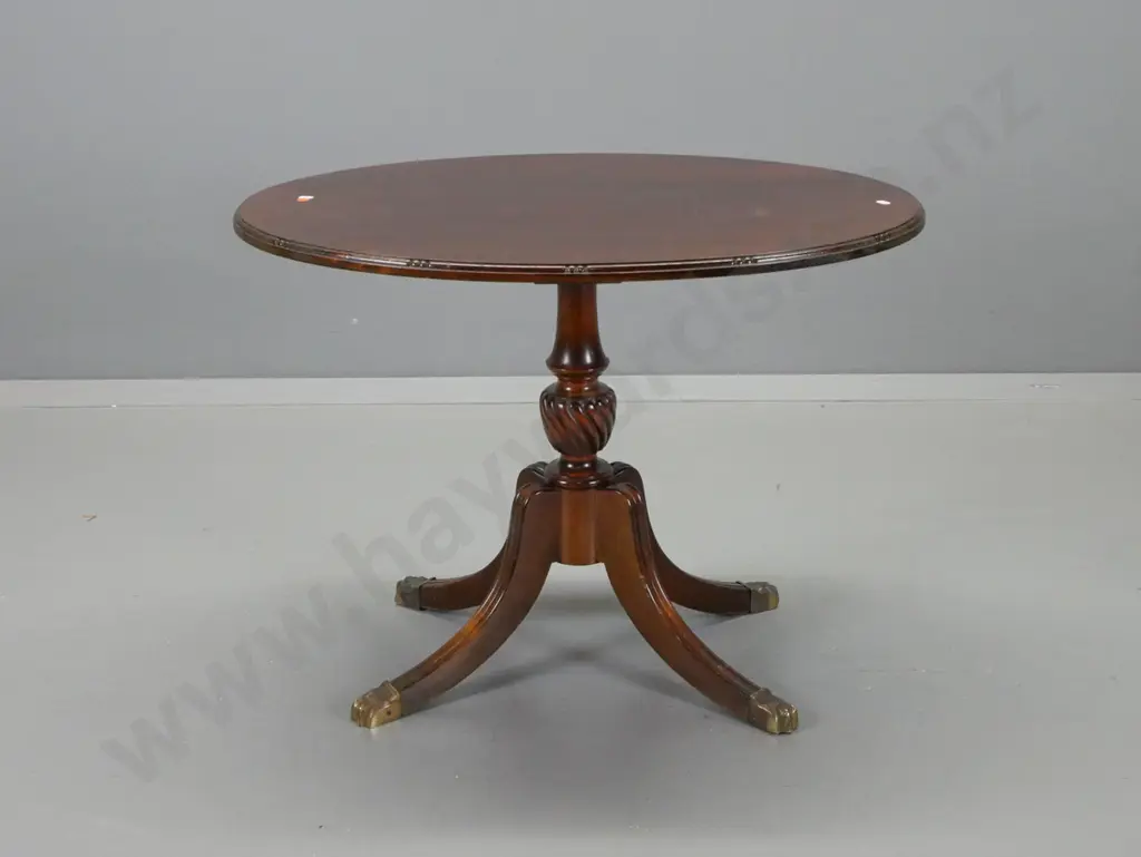mahogany oval pedestal wine table with shaped top edge, 4 sweeping shaped legs, brass paw feet - deterioration to polish Image 1++