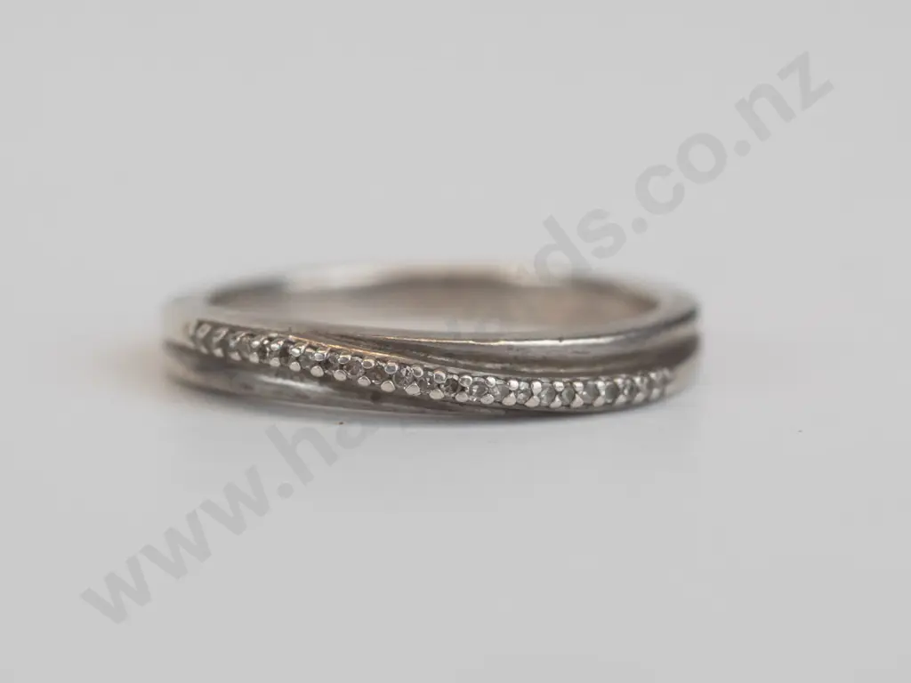 silver ring  set in a crossover ribbon set over white stones Image 1++