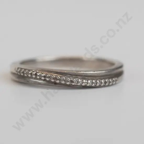 silver ring  set in a crossover ribbon set over white stones