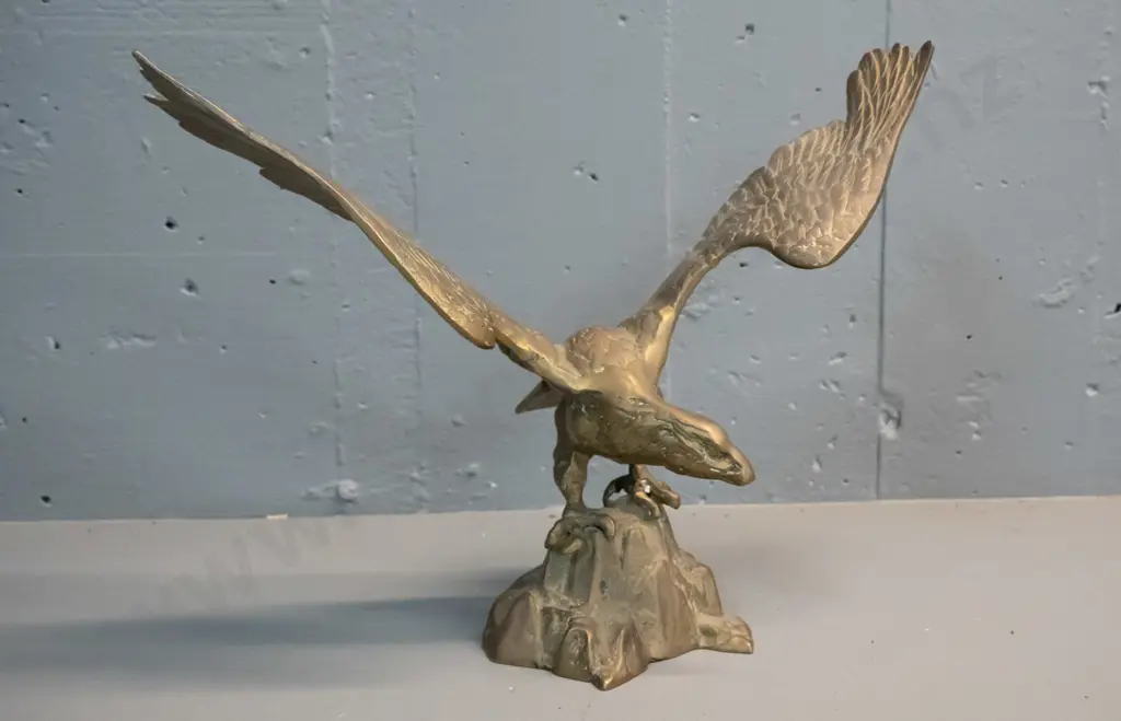 cast brass figure of an eagle with wings spread, standing on rocks - crack to one wing H-285 W-390 Image 1++