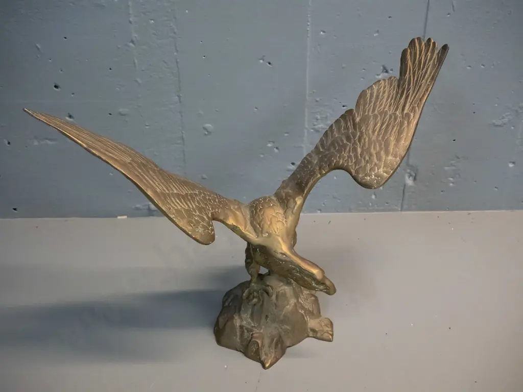 cast brass figure of an eagle with wings spread, standing on rocks - crack to one wing H-285 W-390 Image 1++